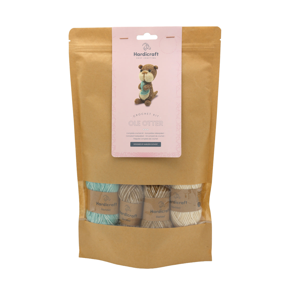 Hardicraft DIY Crochet Kit - Ole Otter - Brown packaging with a pink vertical label and a window showing four balls of yarn in colors, teal, brown and cream.