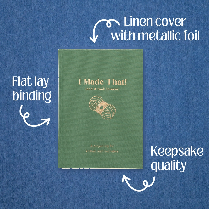 A green keepsake book titled 'I Made That! (and it took forever)' shown on a blue textured background with white callout arrows and text describing features: linen cover with metallic foil, flat lay binding, and keepsake quality.