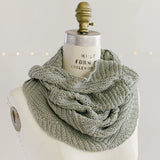 Villa Cowl by Quince & Co. in sage green, wrapped around a dress form neck as a cowl