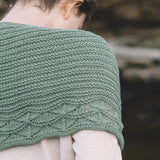 Close-up of the Cave Point shawl’s garter stitch body and leaf lace border, knit in green Quince & Co. Chickadee