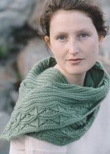 Woman wearing the Cave Point shawl wrapped around her neck, knit in Quince & Co. Chickadee, designed by Paula Emons-Fuessle